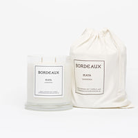 Thumbnail for Gardenia fragranced 380g candle in a classic glass jar with knob lid next to a candle in drawstring cotton bag | Bordeaux Candles