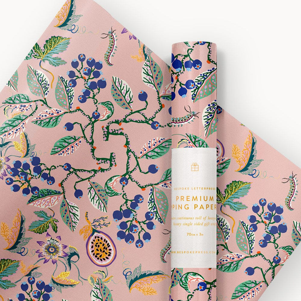 Roll of floral-patterned paper with a cylindrical product labeled 'Premium Writing Paper' on a white background